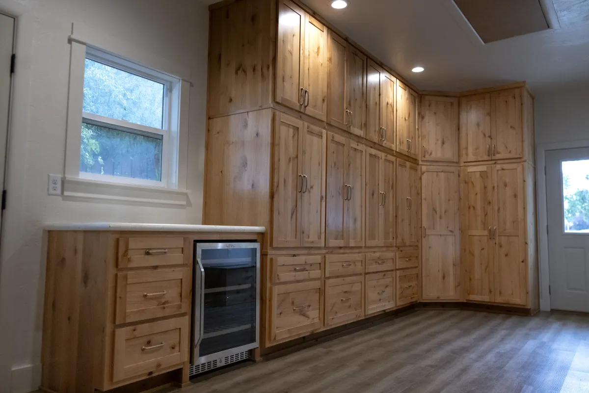 Custom built-in corner cabinetry with wine fridge