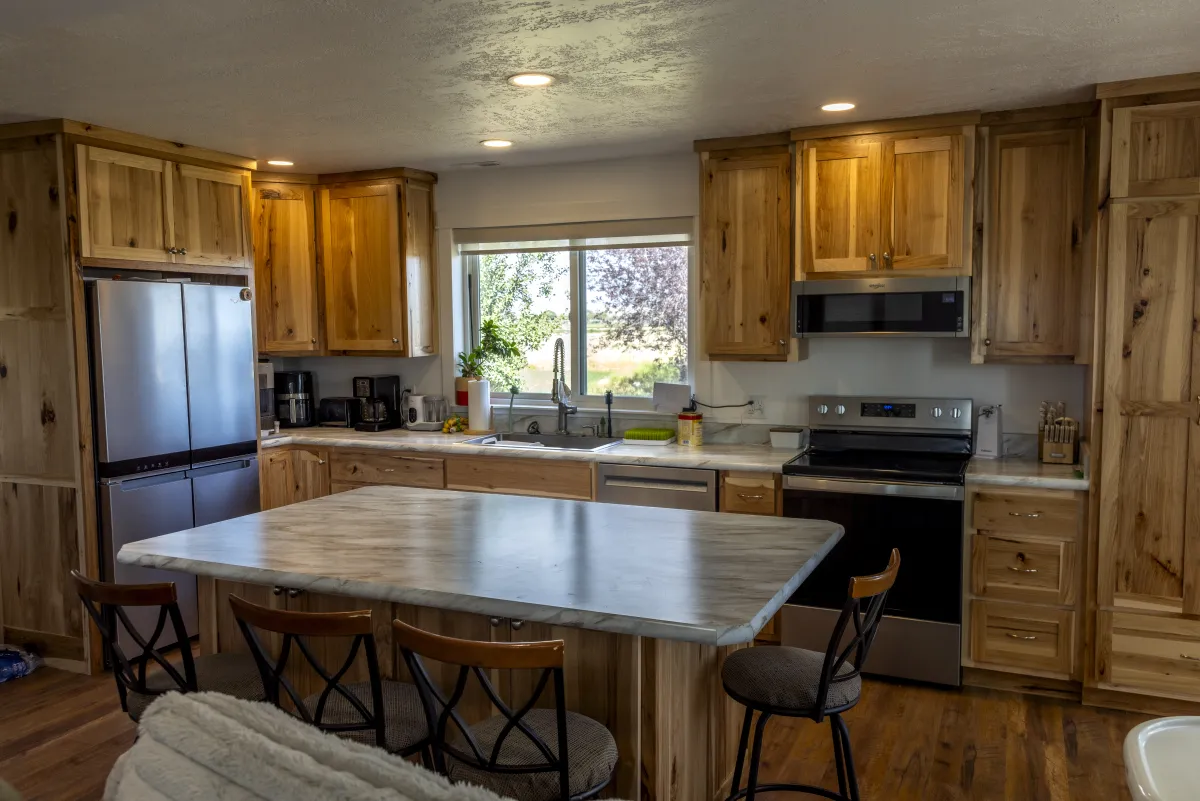 Modern kitchen remodel with hickory cabinets and marble island