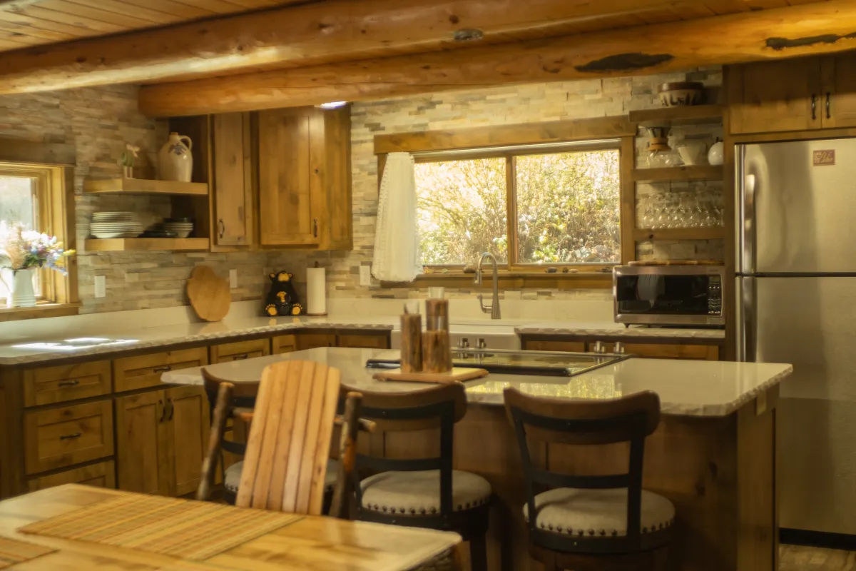 Rustic log cabin kitchen remodel by Pilot Peak Construction