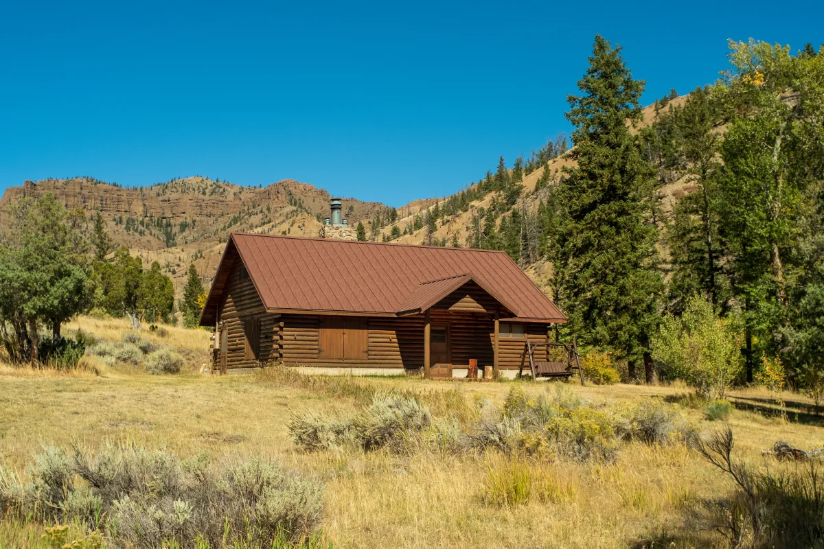 Brown metal roof on log cabin in Wyoming by Pilot Peak Construction