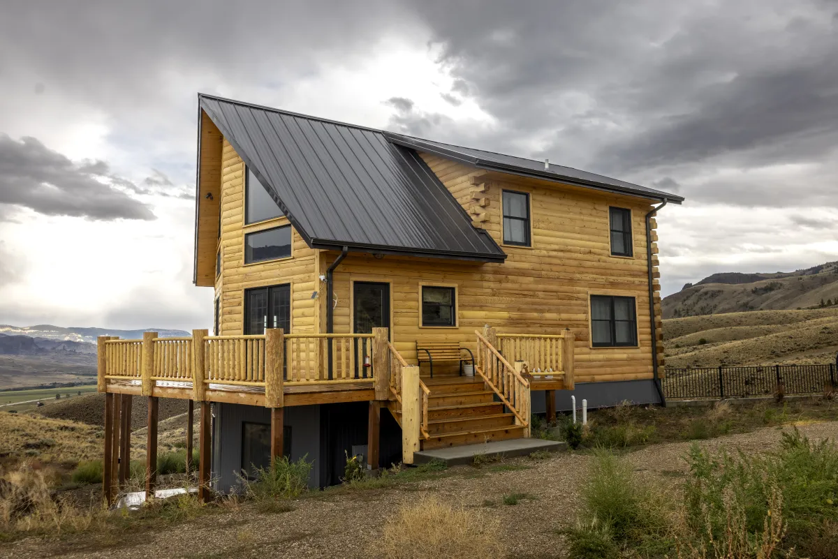 Standing seam metal roof on log cabin by Pilot Peak Construction