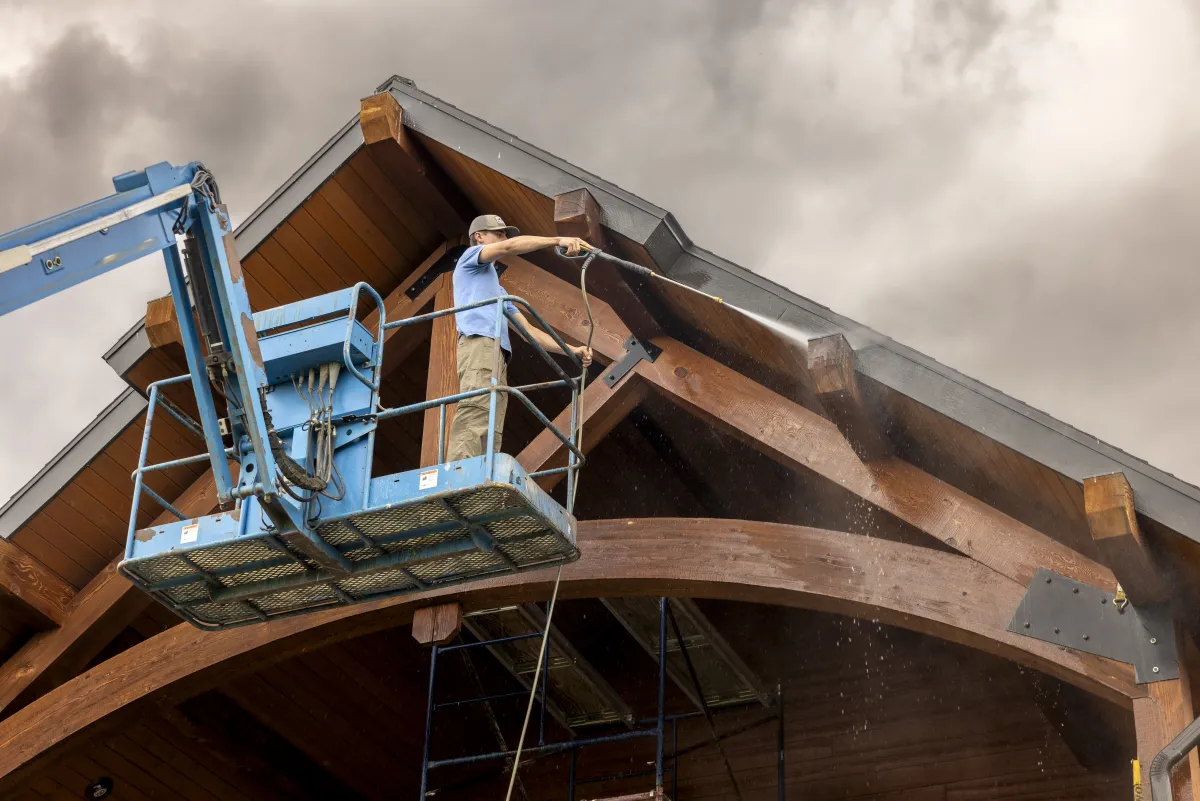 Close-up of exterior staining work from boom lift by Pilot Peak Construction